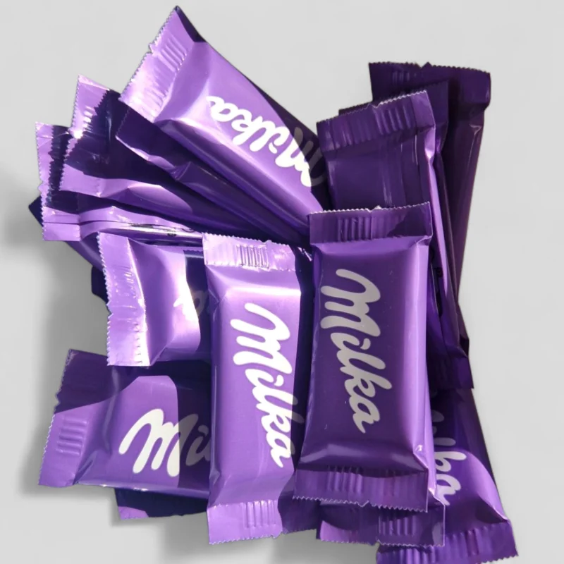 Milka pieniško šokolado saldainiai